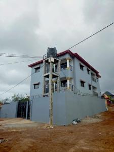 a white building with a fence in front of it at Keitaya Dubreka Guinea in Conakry