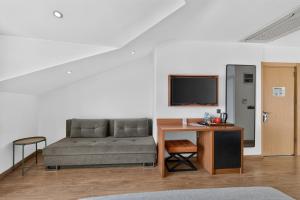 a living room with a couch and a desk at La Farine Rooms in Fethiye