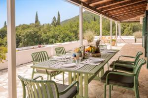 a table and chairs on a patio with a view at Sunrise Stone Villa in Agios Nikolaos