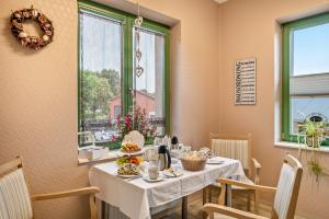 a dining room with a table with food on it at Pension Pusteblume in Meyenburg