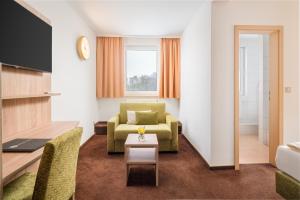 a living room with a couch and a table at Lübsche Thorweide in Wismar