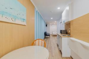 a kitchen with a table and a dining room at Bocage Blue Heaven I, By Home Match in Setúbal