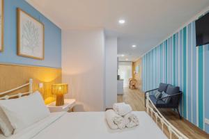 a bedroom with a bed with towels on it at Bocage Blue Heaven I, By Home Match in Setúbal