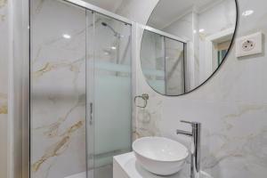a bathroom with a shower and a sink and a mirror at Bocage Blue Heaven I, By Home Match in Setúbal +14 photos