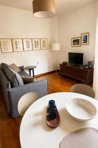 a living room with a couch and a table at Verde Acqua two Apartments in Lecco +42 photos