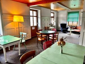 a room with tables and chairs and a couch at Garni Sternen in Obstalden