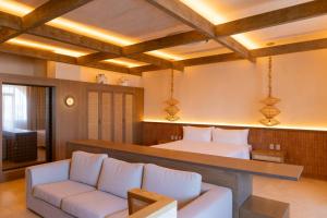 a bedroom with a bed and a couch in a room at Hotel El Balconario by Faranda Boutique in Cartagena de Indias +8 photos