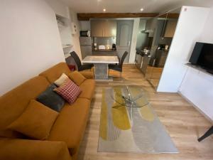 a living room with a couch and a table at Orry d'Oriège in Ax-les-Thermes +22 photos