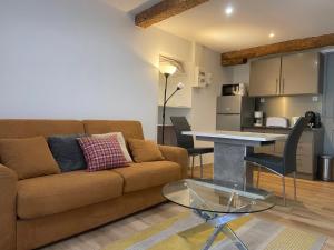 a living room with a couch and a table at Orry d'Oriège in Ax-les-Thermes