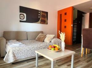 a living room with a couch and a bowl of fruit on a table at Green Garden Gajac in Gajac +4 photos