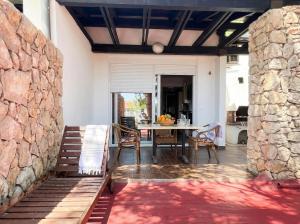 a patio with a table and chairs and a stone wall at Green Garden Gajac in Gajac