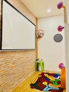 a room with a large projection screen on a brick wall at The Miá home in Can Tho +25 photos