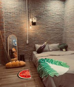 a room with two beds and a brick wall at The Miá home in Can Tho