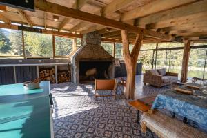 a living room with a fireplace in a house at Peuma Lodge Patagonia in Futaleufú