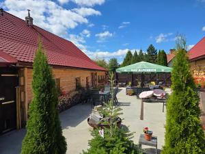 a patio with a table and a green umbrella at Beskydy Areal in Prostřední Bečva