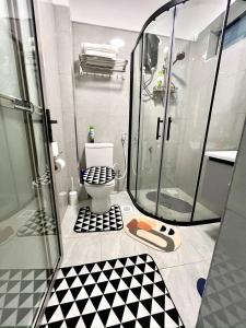 a bathroom with a shower and a toilet at Skyline Westlands with Gym in Nairobi +23 photos