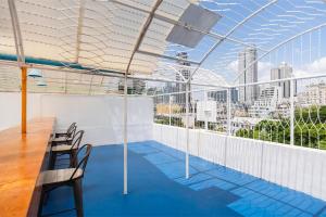 a balcony with chairs and a view of the city at Arawana Hostel Silom in Bangkok