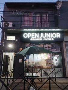 a green umbrella sitting in front of a restaurant at Departamento en Ezeiza - SA in La Unión