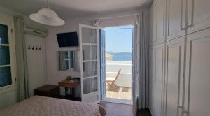 a bedroom with a bed and a view of the ocean at Panoramic View apartment in Poros