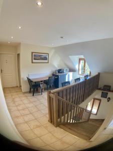 a kitchen and dining room with a staircase in a house at Beauval Chambre in Seigy