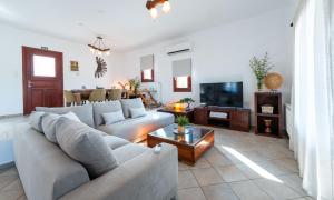 a living room with a couch and a tv at Keiz Retreat in Ermoupoli