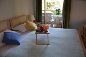 a bedroom with a bed with a table with drinks on it at Hotel Imperiale in Fiuggi