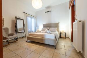a bedroom with a bed with a mirror and a chair at Keiz Retreat in Ermoupoli +36 photos