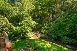 an overhead view of a garden with two chairs and a bridge at Waterfall Cottage in Boone