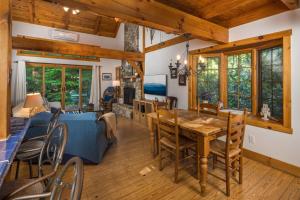 a dining room and living room with a table and chairs at Waterfall Cottage in Boone +28 photos