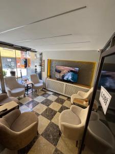 a waiting room with chairs and a fireplace at Silvercity Hotel&Suits in Eskisehir