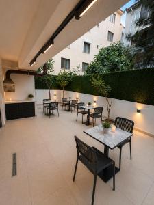 a patio with tables and chairs in a building at Silvercity Hotel&Suits in Eskisehir