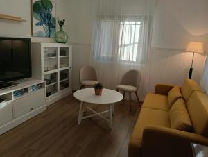 a living room with a couch and a table at Cereza Home in Cabezuela del Valle