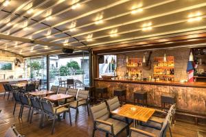 a restaurant with tables and chairs and a bar at Elotis Suites in Agia Marina Nea Kydonias +49 photos