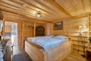 a bedroom with a bed in a wooden room at Beskydy Areal in Prostřední Bečva +168 photos