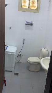 a white bathroom with a toilet and a sink at شوران الفاخرة 2 in Medina