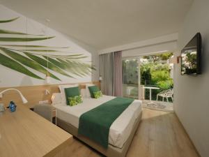a hotel room with a bed and a balcony at BQ Paguera Boutique Hotel - Adults Only in Paguera