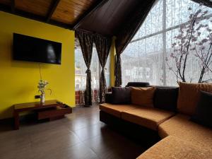a living room with a couch and a large window at Anagrama house in Baños