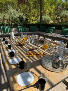 a long table with plates of food on it at Palais Nohe in Marrakesh