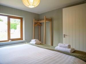 a bedroom with a bed with towels on it at Cottage on the Lane Dingle in Dingle