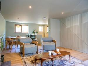 a living room with chairs and a table at Cottage on the Lane Dingle in Dingle