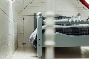 a bedroom with a bunk bed in a attic at The Croft Collective in Oban
