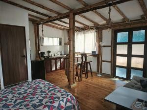 a bedroom with a bed and a kitchen with a table at Suite Central Campestre - Casa Matula in Popayan