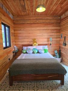 a bedroom with a bed in a wooden room at Altos del Dragón in Valle de Anton