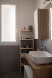 a bathroom with a white sink and a window at Albergo Vittoria in Rimini +50 photos