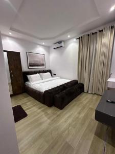 a bedroom with a bed and a couch in it at Raya in Lagos +5 photos