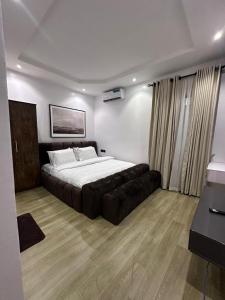 a bedroom with a large bed and a couch at Raya in Lagos