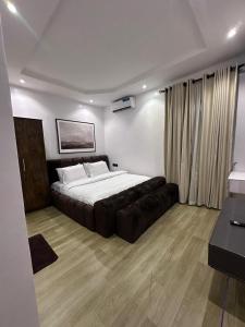 a bedroom with a large bed and a couch at Raya in Lagos