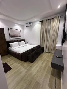 a bedroom with a large bed and a couch at Raya in Lagos