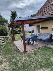 a wooden deck with a table and chairs on it at Volšovy Apartment in Sušice