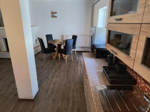 a living room with a dining room table and chairs at Volšovy Apartment in Sušice